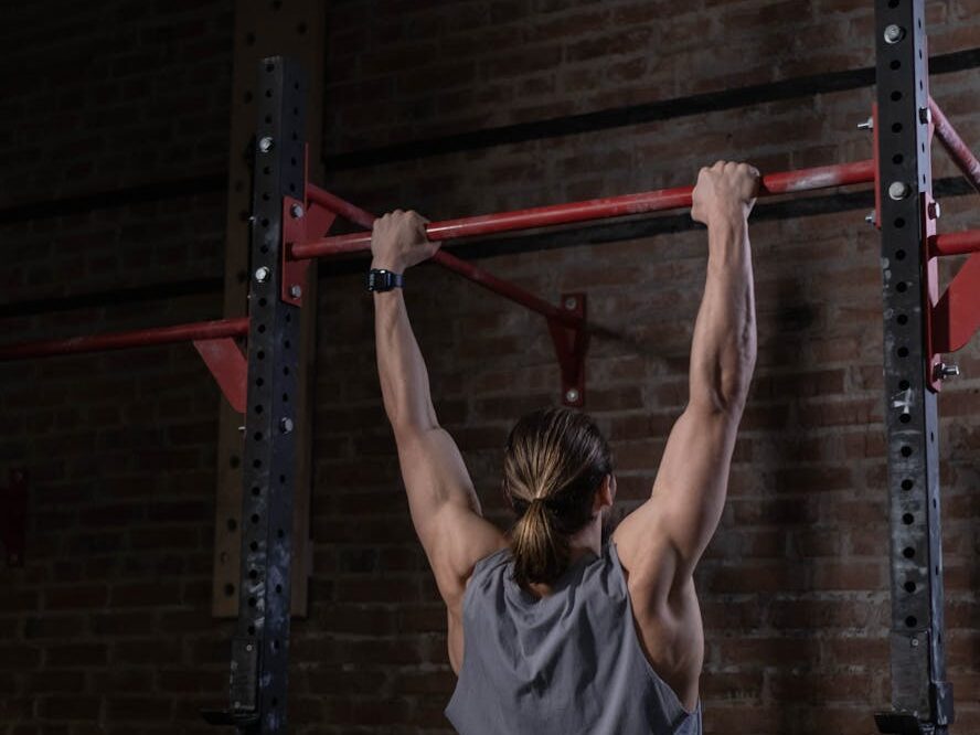 Person using grip and holding on to pullup bar