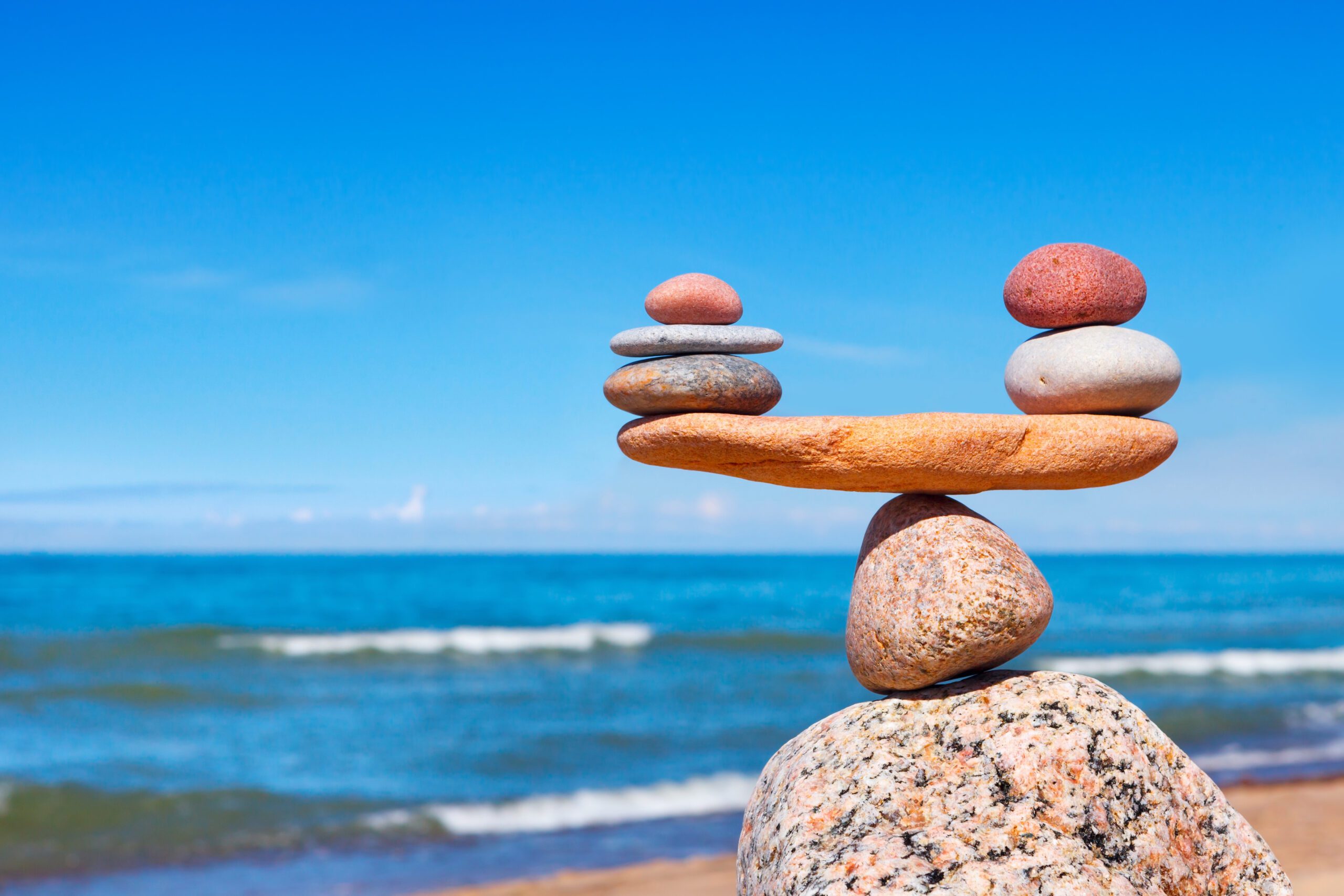 Rocks balancing on beach representing stress scale