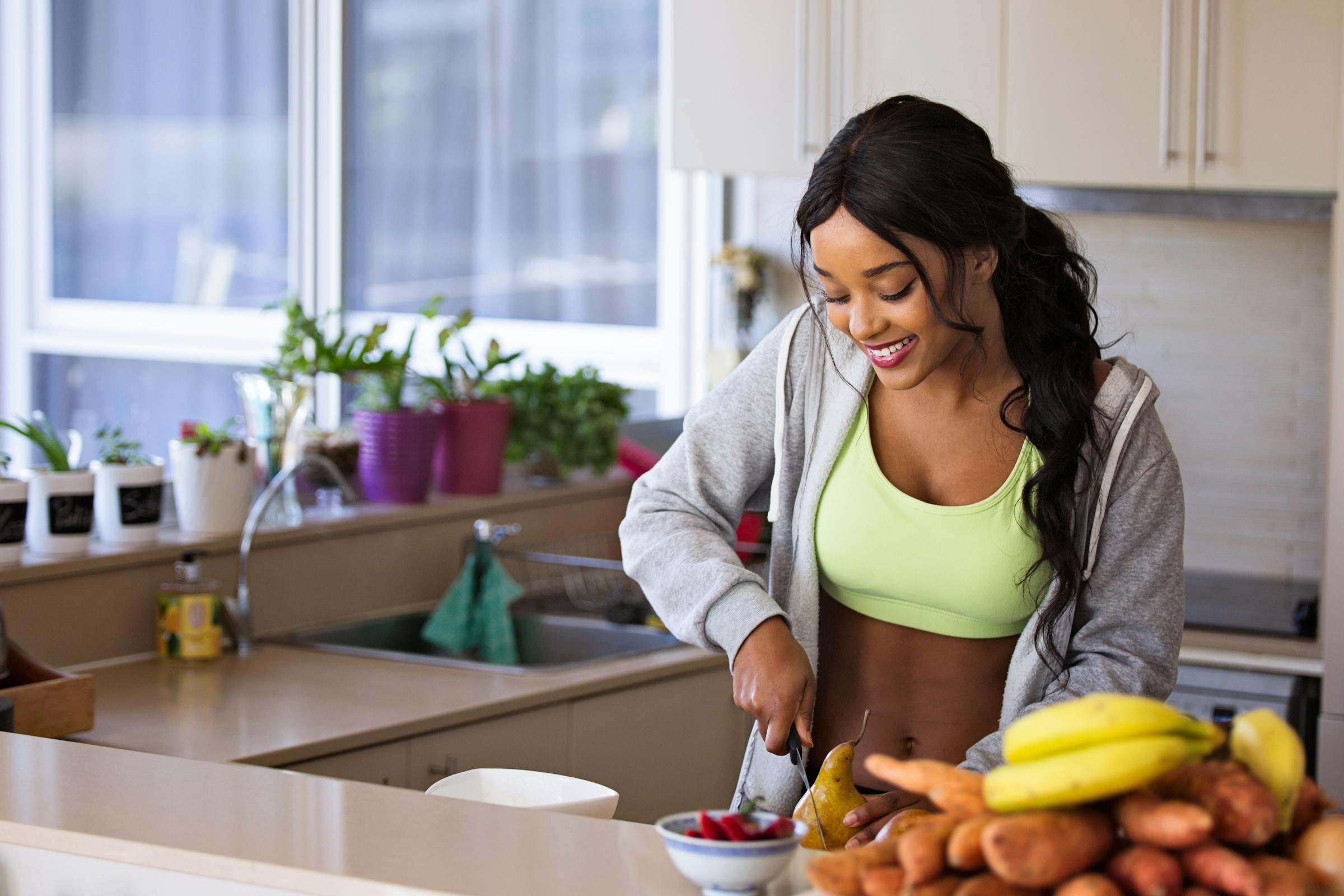 Woman preparing food to eat in kitchen