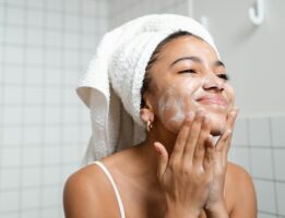 Woman washing her face for self care
