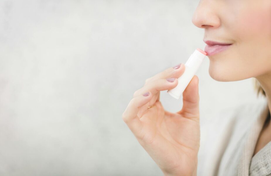 Woman using chapstick