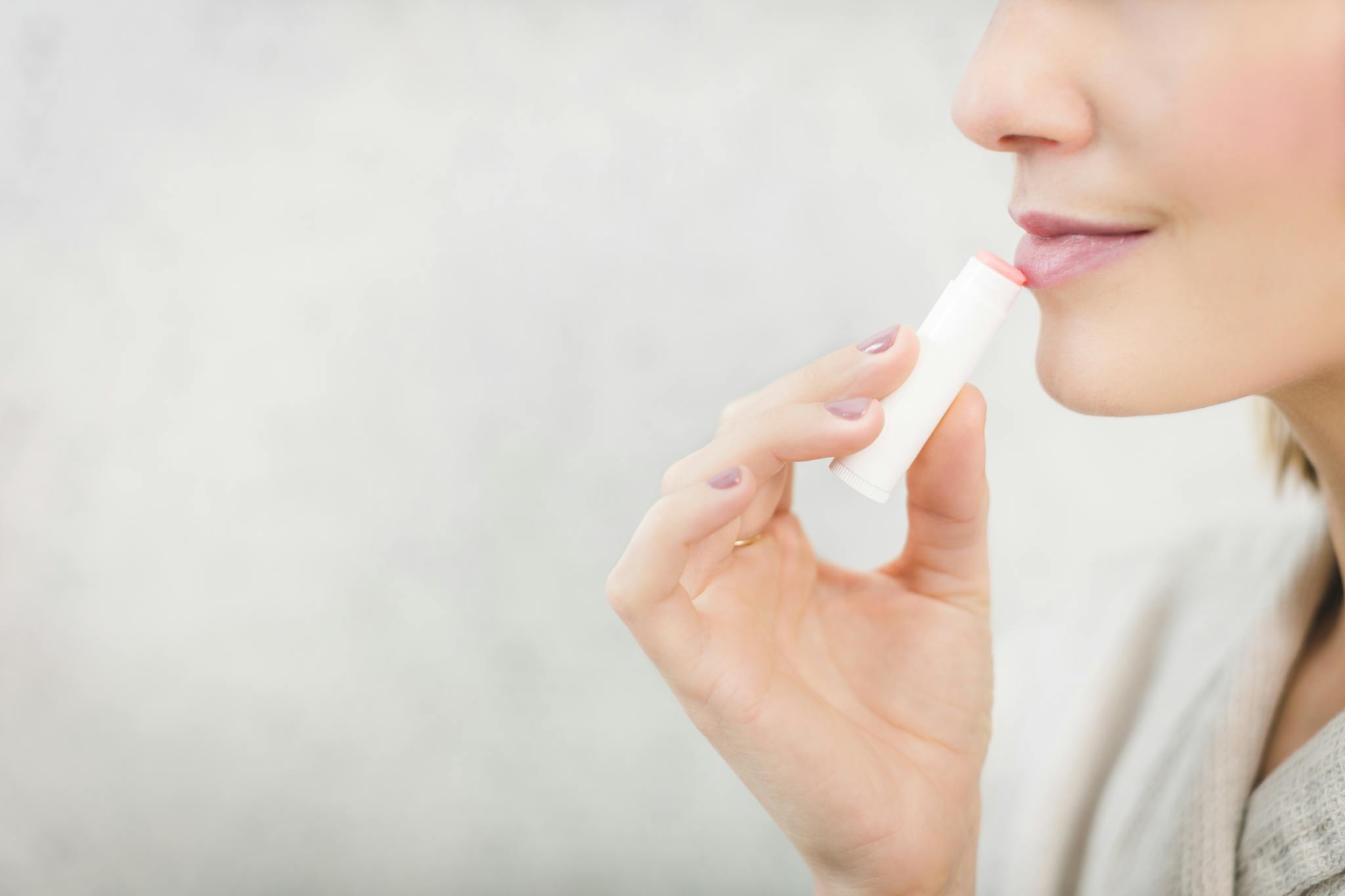 Woman using chapstick