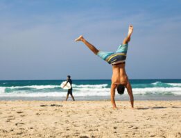 Man doing cartwheels at the beach